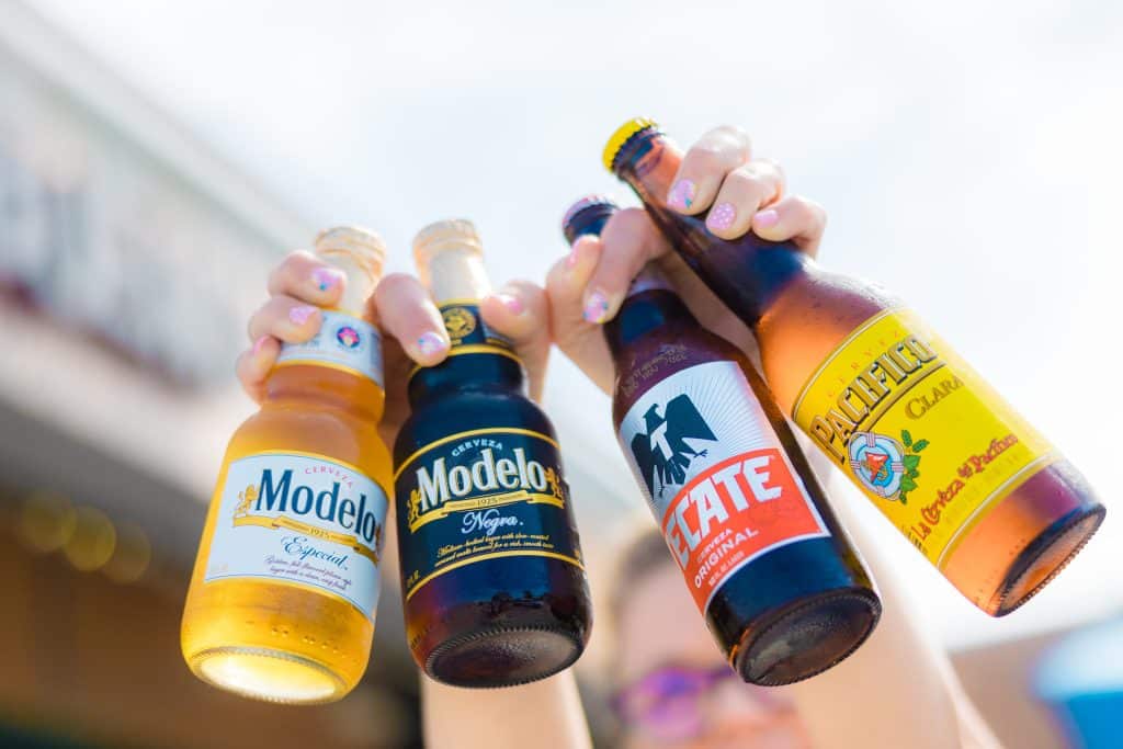 A closeup photo of various bottles of cold beer.